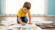© Tgad - Young enthusiastic boy intently drawing colorful pictures with pencils and crayons on the floor at home creating art and learning