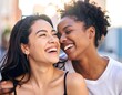 © boivinnicolas - A tight, vibrant close-up capturing the genuine, laughing faces of two diverse young women sharing a joyful, candid moment.