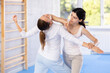 © JackF - Active woman with professional female trainer are training captures on the self-defense course in gym