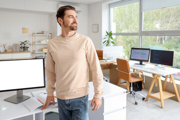 Male programmer at workplace in office