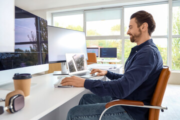 Male programmer at workplace in office