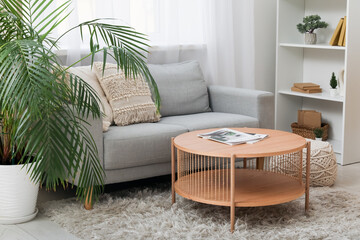 Wall Mural - Table with magazines near sofa in interior of living room