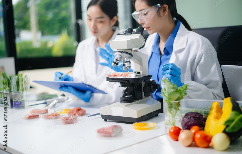 Scientist team testing food samples in lab with microscope, vegetables ...