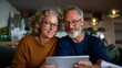 © Z A C - Older couple looking at tablet.