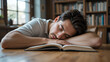 © Lisa - Tired man sleeping near books at wooden table indoors