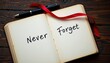 © Athiphat - Flat lay of diary notebook lying open with handwritten phrase 'Never Forget' in bold ink