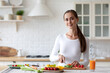 © BestForYou - Woman in her kitchen is cutting vegetables to prepare healthy food, following proper nutrition principles