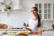 © BestForYou - Woman in the kitchen with electronic tablet preparing fresh vegetables