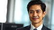 © Clyde Peng - Business professional in formal attire, confident expression with soft office backdrop.