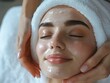 © Zaur - Woman receiving a relaxing facial massage and mask treatment.