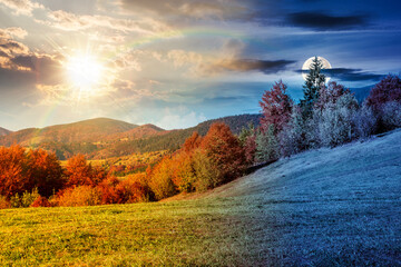 Wall Mural - mountain landscape on autumn equinox. day and night time change concept. beautiful view with trees in colorful foliage. picturesque rural place in alps with sun and moon at twilight. countryside scene