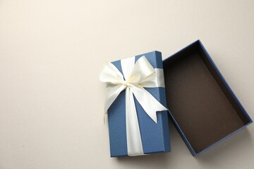 Wall Mural - Open gift box with beautiful lid on light grey background, top view. Space for text