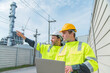 © Mrzproducer - Construction workers in safety gear examine tablet outdoors, showcasing teamwork and collaboration in industrial setting. Their bright jackets and helmets highlight safety in workplace