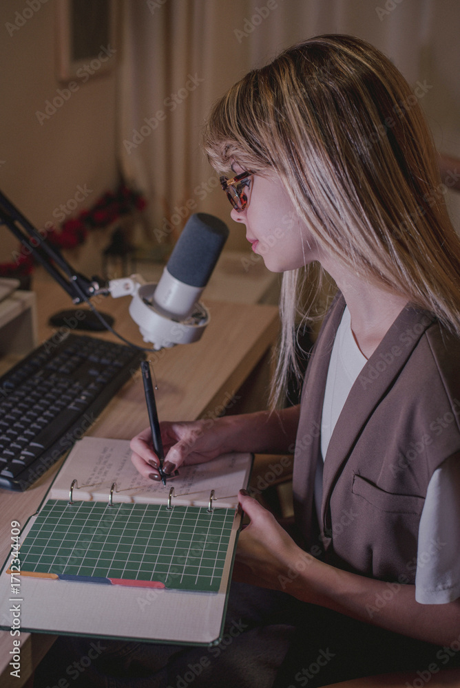 Young woman writing notes in a study environment, focused and ...