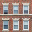 Classic red brick facade with orderly windows revealing timeless urban residential architecture in Cambridge, Massachusetts, USA

