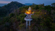 Aerial view of scenery Khao Rang viewpoint at twilight.
view of a town nestled among lush green mountains at sunset, with a Pavilion structure perched on the hillside at Phuket town at Dusk