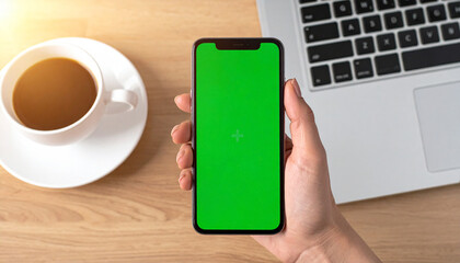 Close up of woman looking at telephone with green screen and chroma key. Adult holding mobile phone with isolated mockup template and background, using chroma-key on telephone display