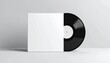 © diadi - Blank white record sleeve with a vinyl record on a plain background - mockup
