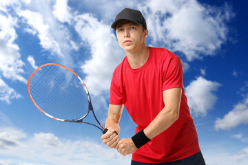 Wall Mural - man playing tennis against blue sky with clouds