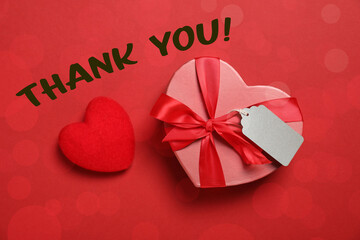 Wall Mural - Thank you card design with heart-shaped gift box on red background. Bokeh effect
