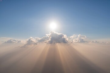 Wall Mural - the sunlight pierces through the clouds, illuminating the entire sky. a serene and peaceful paradise