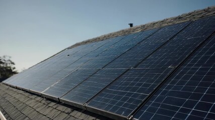 A modern solar panel array installed on a rooftop, symbolizing sustainable energy and eco-friendly technology. The panels are angled towards the sun, harnessing its power