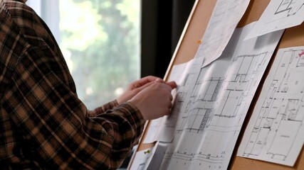 Architectural Plans Being Reviewed on a Notice Board