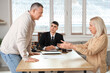 © Pixel-Shot - Quarreling mature couple with lawyer in office