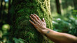 © Herma - Close-up of hand touching moss-covered tree trunk in forest, symbolizing eco-consciousness, connection with nature, sustainability, and appreciation for the environment