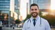 © dony - Smiling Male Doctor in White Coat Standing in Sunny City Street