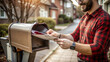 © Margo Miro - Close-up of a mail carrier retrieving letters from a mailbox in a residential neighborhood