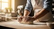 © Abdul - Person Kneading Dough in Kitchen with Warm Natural Light