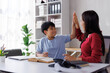 © Phimwilai - Asian teacher and student giving high five after successful homeschooling lesson