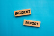 © Emre Akkoyun - Incident report message written on wooden blocks on blue background. Conceptual incident report symbol. Copy space.