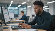 © Olga - Focused businessman working on computer in office