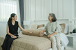 © APchanel - Real estate agent consulting elderly customer inside modern home details on digital tablet symbolizing property advice, housing investment or home purchase decisions and supportive customer care.