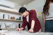 © Natee Meepian - Focused Designer Working on Laptop in Creative Office