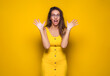 © Alen-D - Surprised woman looking to you, isolated on yellow background. Freak out girl.