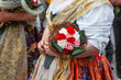 Flower bouquet in women hands. Parade in Villajoyosa celebrated feast of Santa Marta, the patron saint of city, with participants offering flowers as part of traditional tribute