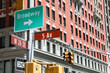 street sign showing the intersection of Broadway and 5th Avenue in NYC
