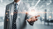 © Made - Businessman holding a glowing digital interface with a central gear, symbolizing technology, automation, and innovation.