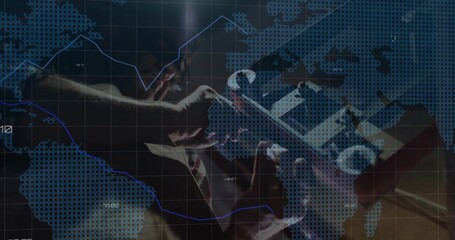 Wall Mural - Holding tablet in suit and tie examining financial overlays in office, world map grid, trend arrow