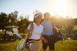 © Drazen - Happy couple of golfers enjoying in playing golf at sunset.