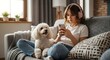 © Welaine - Cozy Harmony: A young woman relaxed on a comfortable couch, engrossed in her phone while her fluffy companion, a poodle, rests peacefully beside her.