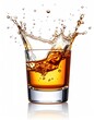 © Piring - Amber liquid splashing into a short glass, creating a dynamic crown-shaped splash against a stark white background.  A subtle reflection is visible below