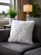 © Mselected - Soft white pillow on a cozy gray couch in a bright living room