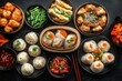 © Liliya - Assorted steamed dumplings, including soup dumplings and topped with herbs and roe, with dipping sauces and side dishes arranged on a dark surface conveying a rich and appetizing meal