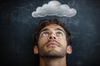 © du - Young man looking thoughtfully up at a chalk-drawn cloud on a blackboard background, expressing contemplation and daydreaming