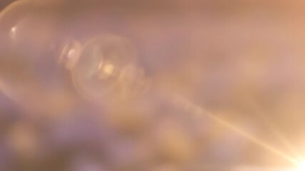 Wall Mural - watch a seamlessly looping video with a delicate, soft lens flare subtly moving across the frame, ev
