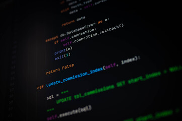 close-up of python code with sql update function and database error handling using rollback and exit